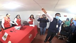 El funcionario muestra la cara de la moneda que se usó para el desempate, Curculla, Perú 22/10/2022