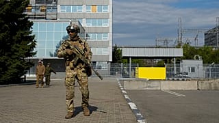 A Russian serviceman stands guard in an area of the Zaporizhzhia Nuclear Power Station, 1 May 2022