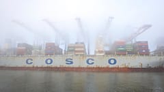 The container ship "Cosco Pride" lies in dense fog at the Tollerort container terminal at the harbor in Hamburg, Germany, Wednesday, Oct. 26, 2022.