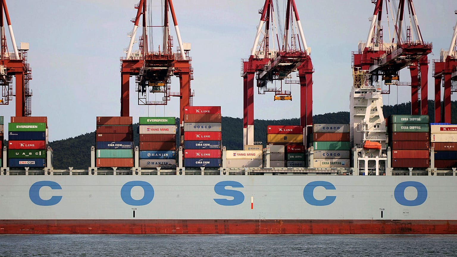 Containers are loaded onto a COSCO container ship at a port in Qingdao in eastern China's Shandong Province in 2016