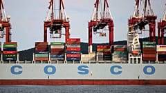 Containers are loaded onto a COSCO container ship at a port in Qingdao in eastern China's Shandong Province in 2016