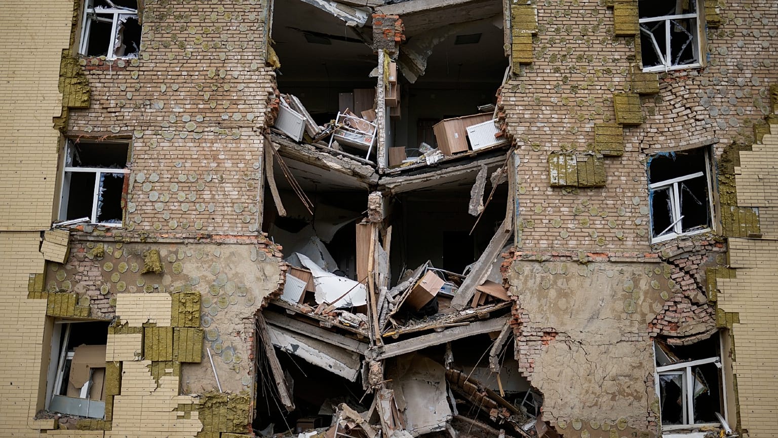 Debris hangs from a residential building heavily damaged in a Russian bombing in Bakhmut, eastern Ukraine, eastern Ukraine, Saturday, May 28, 2022. 