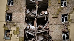 Debris hangs from a residential building heavily damaged in a Russian bombing in Bakhmut, eastern Ukraine, eastern Ukraine, Saturday, May 28, 2022. 