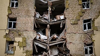 Debris hangs from a residential building heavily damaged in a Russian bombing in Bakhmut, eastern Ukraine, eastern Ukraine, Saturday, May 28, 2022.