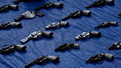 Seized pistols are presented to the media before they are set to be destroyed at police headquarters in Panama City, Aug. 26, 2022.