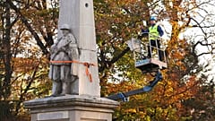 A worker stands on a crane during dismantling of a Red Army monument in Glubczyce, Poland.