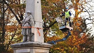 A worker stands on a crane during dismantling of a Red Army monument in Glubczyce, Poland.