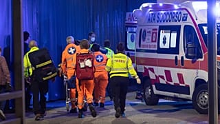 Medics wheel an injured person into an ambulance at the scene of an attack in Milan, Italy, Thursday Oct. 27, 2022