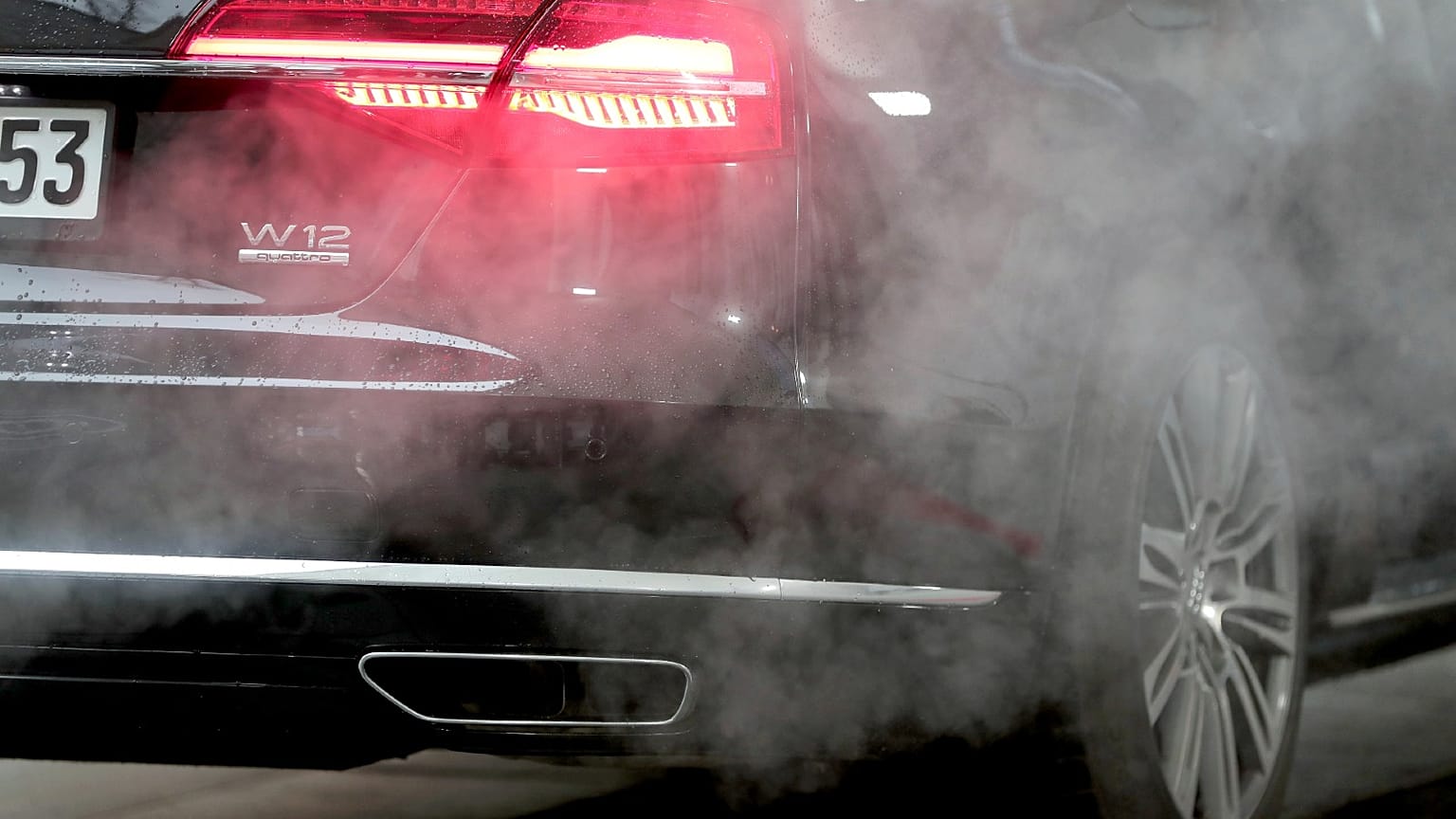 A luxury Audi car is surrounded by exhaust gases as it is parked with a running engine in front of the Chancellery in Berlin, Germany, Nov. 20, 2019.