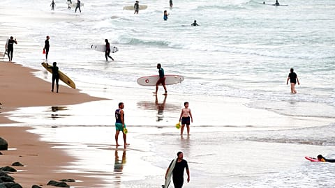 Surfers on the beach at the Basque coast in Biarritz, southwestern France, Thursday, Oct. 27, 2022. 