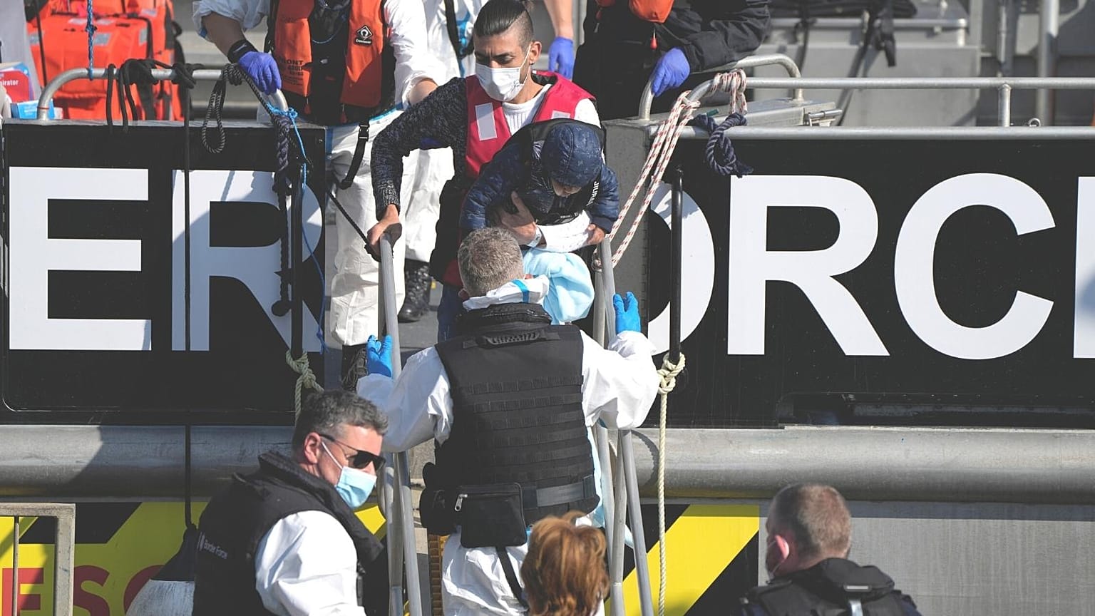FILE: Migrants disembark from a British Border Force boat after being picked up from a dingy in the English Channel, 16 Sept 2021