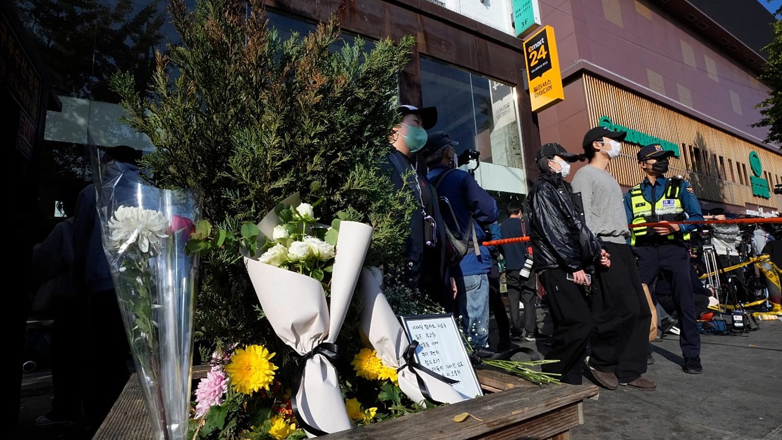 Flowers are seen near the scene of a deadly accident in Seoul, South Korea, Sunday, Oct. 30, 2022, following Saturday night's Halloween festivities. 