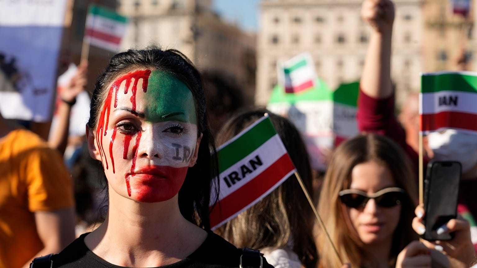 People stage a protest against the death of Mahsa Amini, a woman who died while in police custody in Iran, during a rally in central Rome, Saturday, Oct. 29, 2022. 
