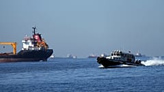A boat with Russian, Ukrainian, Turkish and UN officials heads to inspect cargo ships coming from Ukraine loaded with grain, in the Marmara Sea, Istanbul, Turkey, Oct. 1, 2022