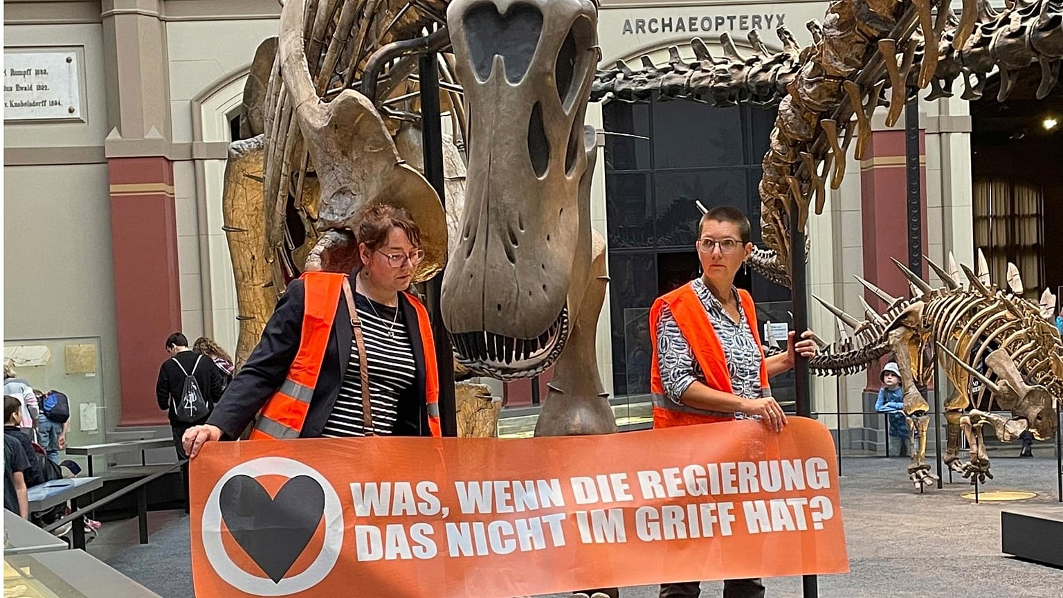 Activists from Germany's Uprising of the Last Generation hold a sign reading, "What if the government doesn't have it under control?"