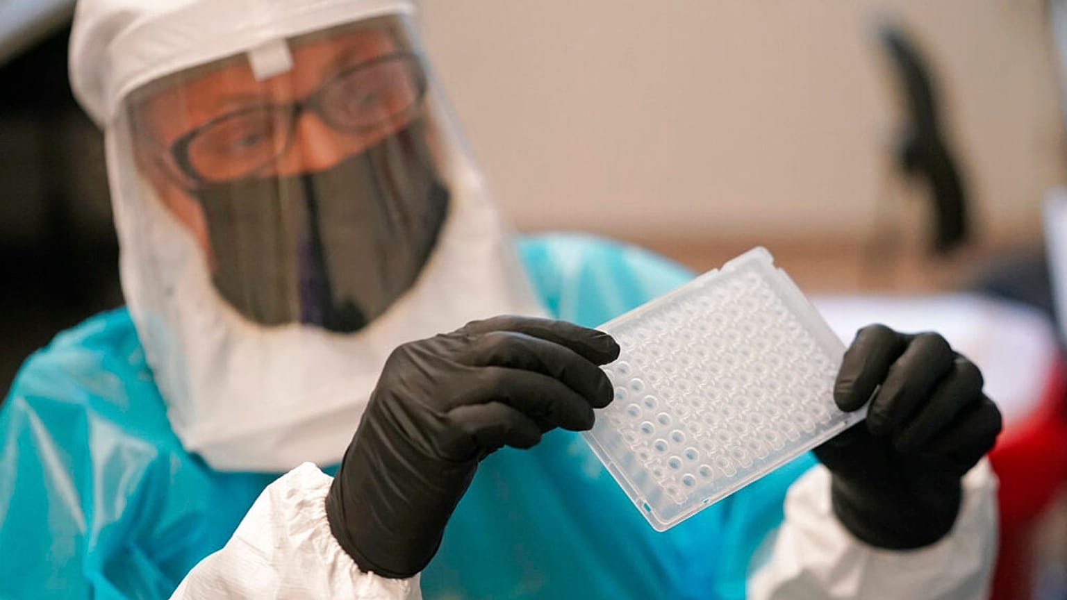 Microbiologist demonstrates how monkeypox is tested for at the Utah Public Health Laboratory