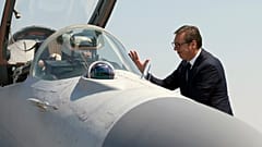Serbian President Aleksandar Vucic speaks with a pilot of MiG-29 jet fighter on the tarmac at Batajnica near Belgrade, August 2018