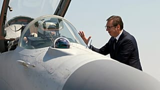 Serbian President Aleksandar Vucic speaks with a pilot of MiG-29 jet fighter on the tarmac at Batajnica near Belgrade, August 2018