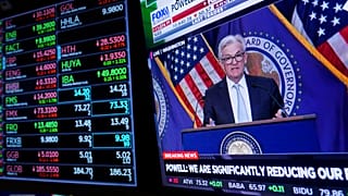 Traders work on the floor at the New York Stock Exchange as the Federal Reserve chairman Jerome Powell speaks after announcing a rate increase in New York