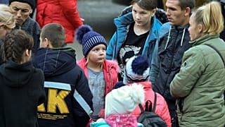 Evacuees from Kherson gather upon their arrival at the railway station in Dzhankoi, Crimea, on Wednesday, Nov. 2, 2022. Kyiv has accused Moscow of "expulsions".