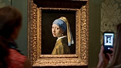 Visitors take pictures of Johannes Vermeer's 'Girl with a Pearl Earring'. 