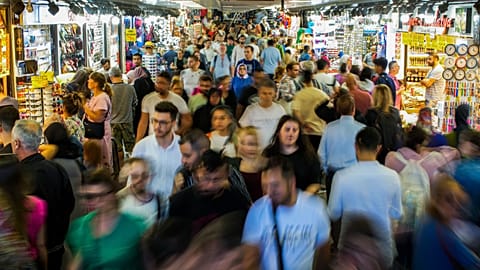 People buy food at the Egyptian spices market in Istanbul.