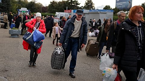 Evacuees from Kherson gather upon their arrival at the railway station in Anapa, southern Russia, Tuesday, Oct. 25, 2022.