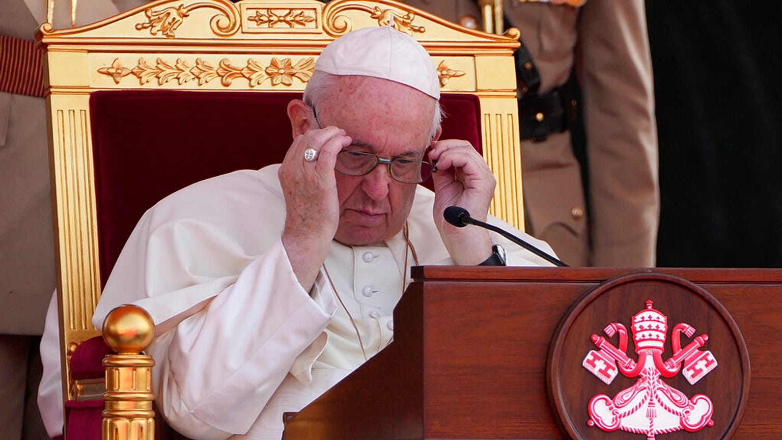 Pope Francis adjusts his glasses, as he attends the closing session of the "Bahrain Forum for Dialogue: East and west for Human Coexistence"
