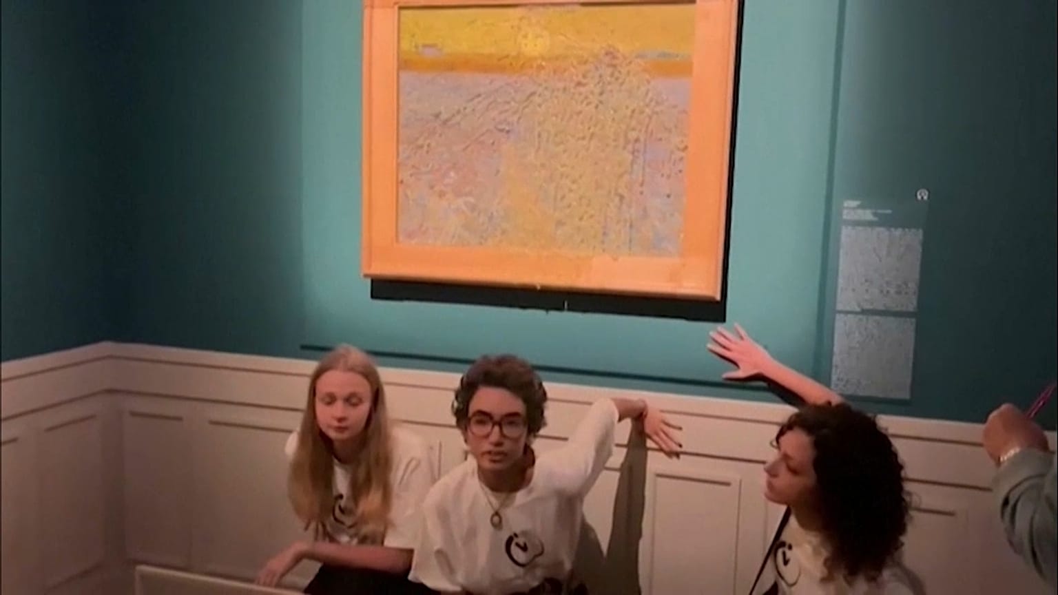 Climate activists glued their hands to the wall after throwing soup at the painting