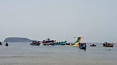 Rescuers in boats are seen around the tail fin of a crashed Precision Air passenger aircraft on the shores of Lake Victoria in Bukoba, 6 November 2022