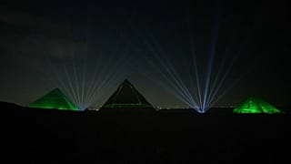 The illuminated pyramids light up the night sky 