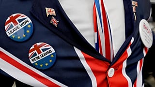 A pro-Brexit supporter wears badges as he demonstrates outside Parliament in London, Oct. 28, 2019.