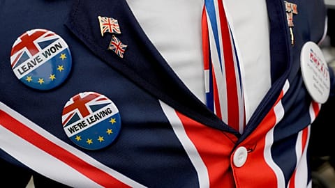A pro-Brexit supporter wears badges as he demonstrates outside Parliament in London, Oct. 28, 2019. 