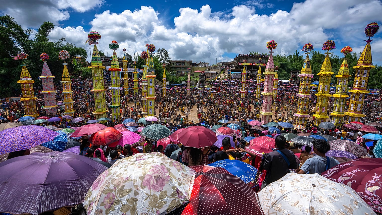 Pnar, or Jaintia, tribals carry 'Rongs' or chariots and dance in muddy waters during the Behdienkhlam festival in Tuber village, in the northeastern India's state of Meghalay.