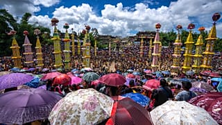 Pnar, or Jaintia, tribals carry 'Rongs' or chariots and dance in muddy waters during the Behdienkhlam festival in Tuber village, in the northeastern India's state of Meghalay.