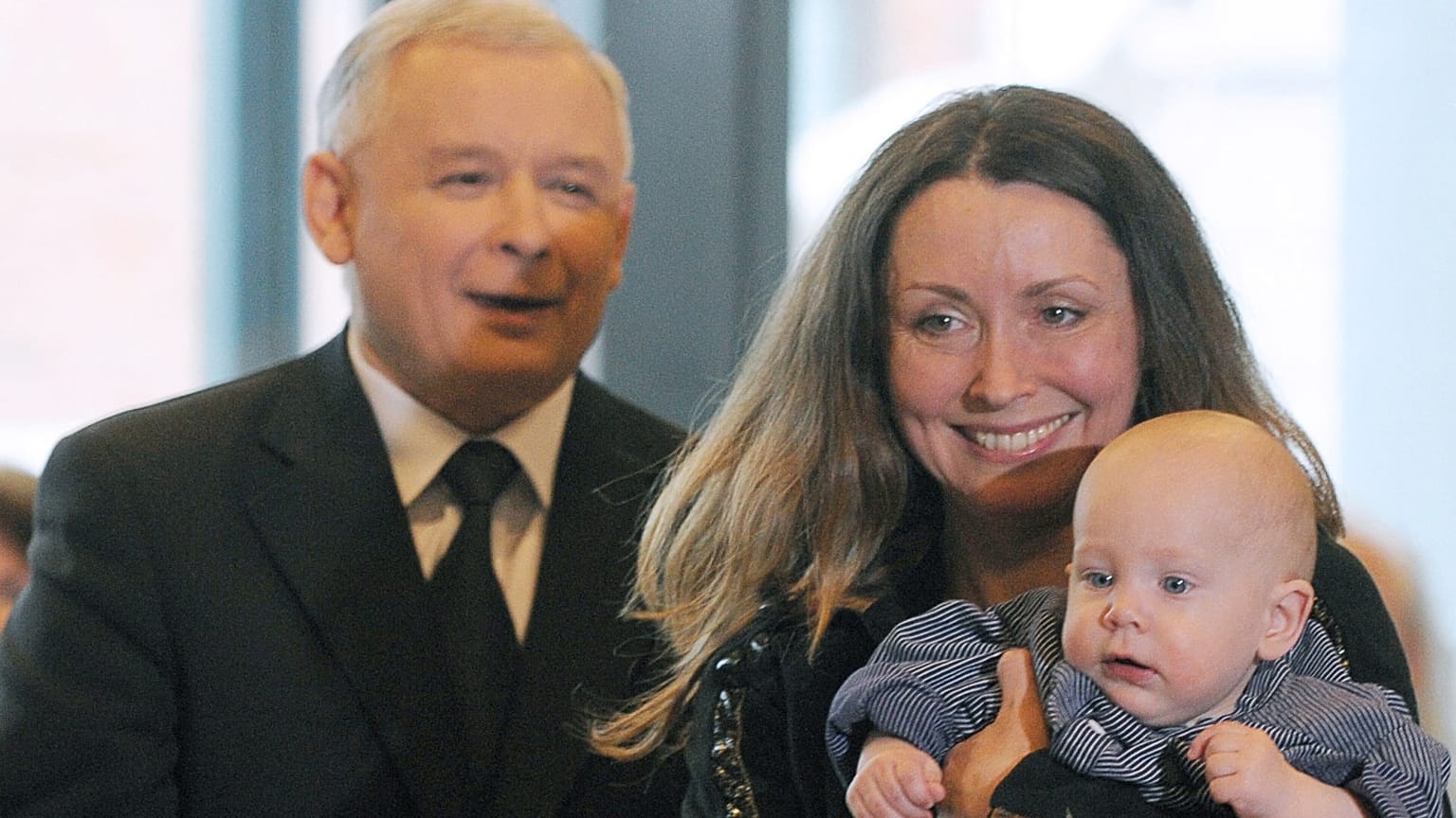 A woman and baby stand near Jaroslaw Kaczynski during a presidential election campaign in 2010.