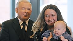 A woman and baby stand near Jaroslaw Kaczynski during a presidential election campaign in 2010.
