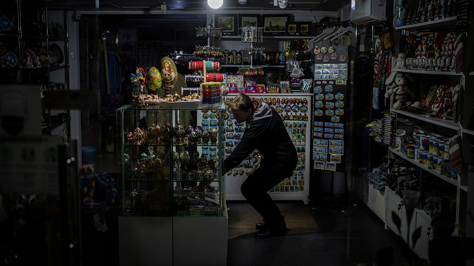 A camping light illuminates a souvenir shop during a power outage in downtown Kyiv
