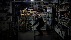A camping light illuminates a souvenir shop during a power outage in downtown Kyiv