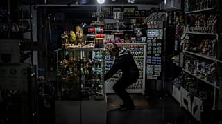 A camping light illuminates a souvenir shop during a power outage in downtown Kyiv