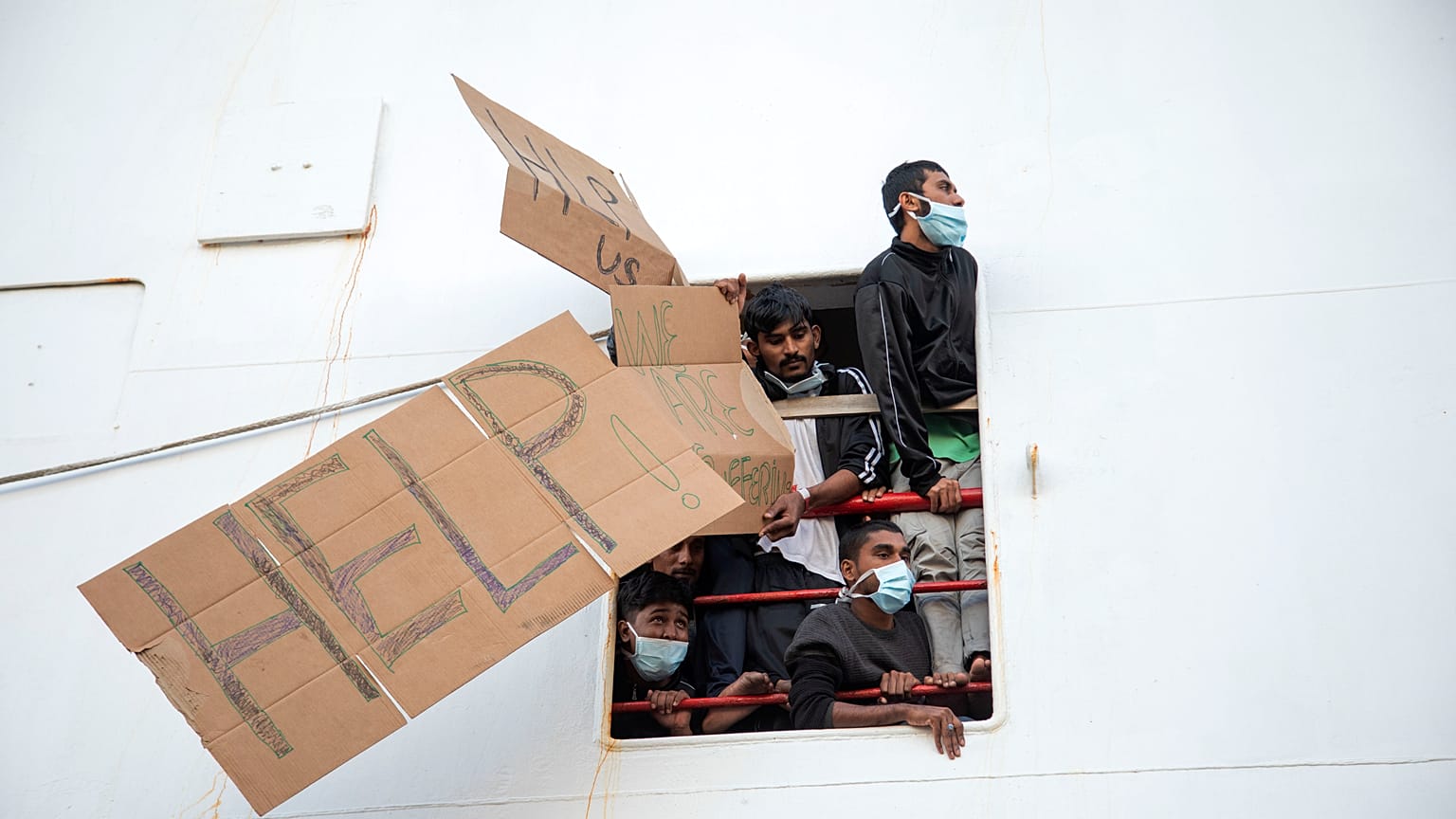Migrants show placards demanding the disembark for all as the wait aboard of the Norway-flagged Geo Barents rescue ship , in Catania's port, Sicily, southern Italy, Nov 8 2022