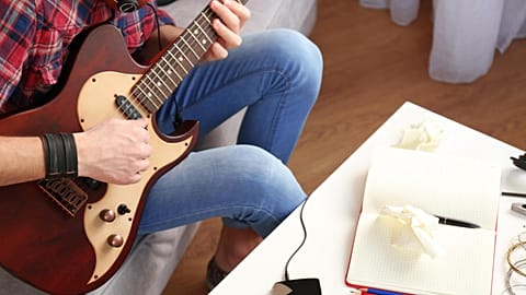 A guitarist writes a new song
