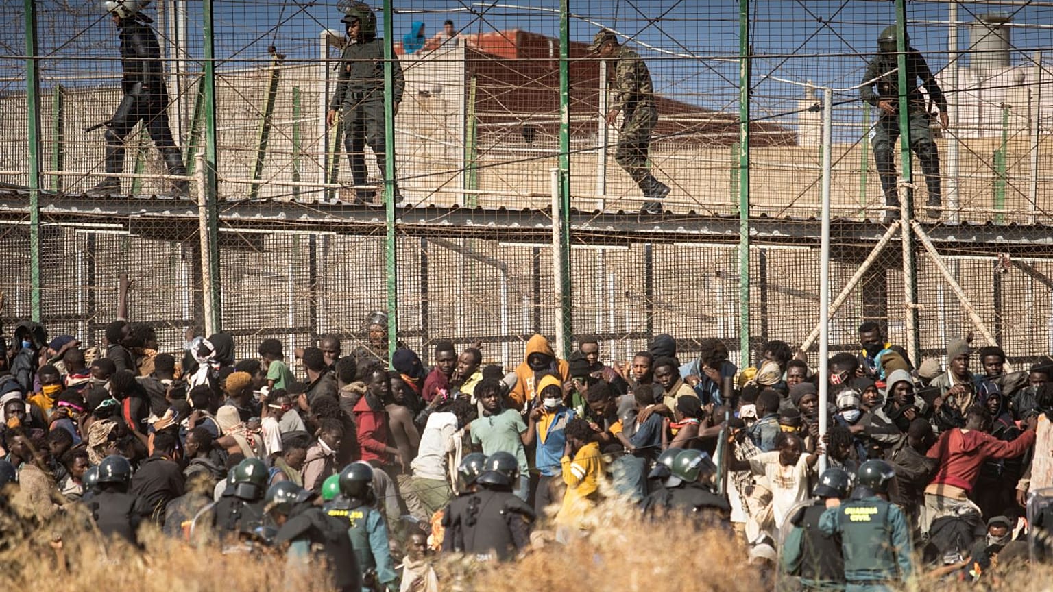 Hundreds of migrants tried to to scale the border fence separating Morocco from Mellila in June.