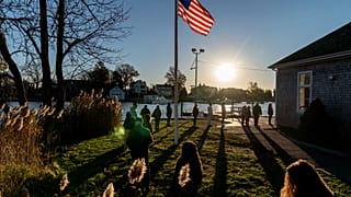 Voters line up to cast their ballots in the midterm election at the Aspray Boat House in Warwick, Rhode Island, Tuesday, Nov. 8, 2022.