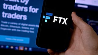 This illustration photo shows a smart phone screen displaying the logo of FTX, the crypto exchange platform.