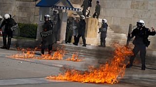 Molotov cocktails were thrown at riot police outside the Greek Parliament during clashes in Athens.
