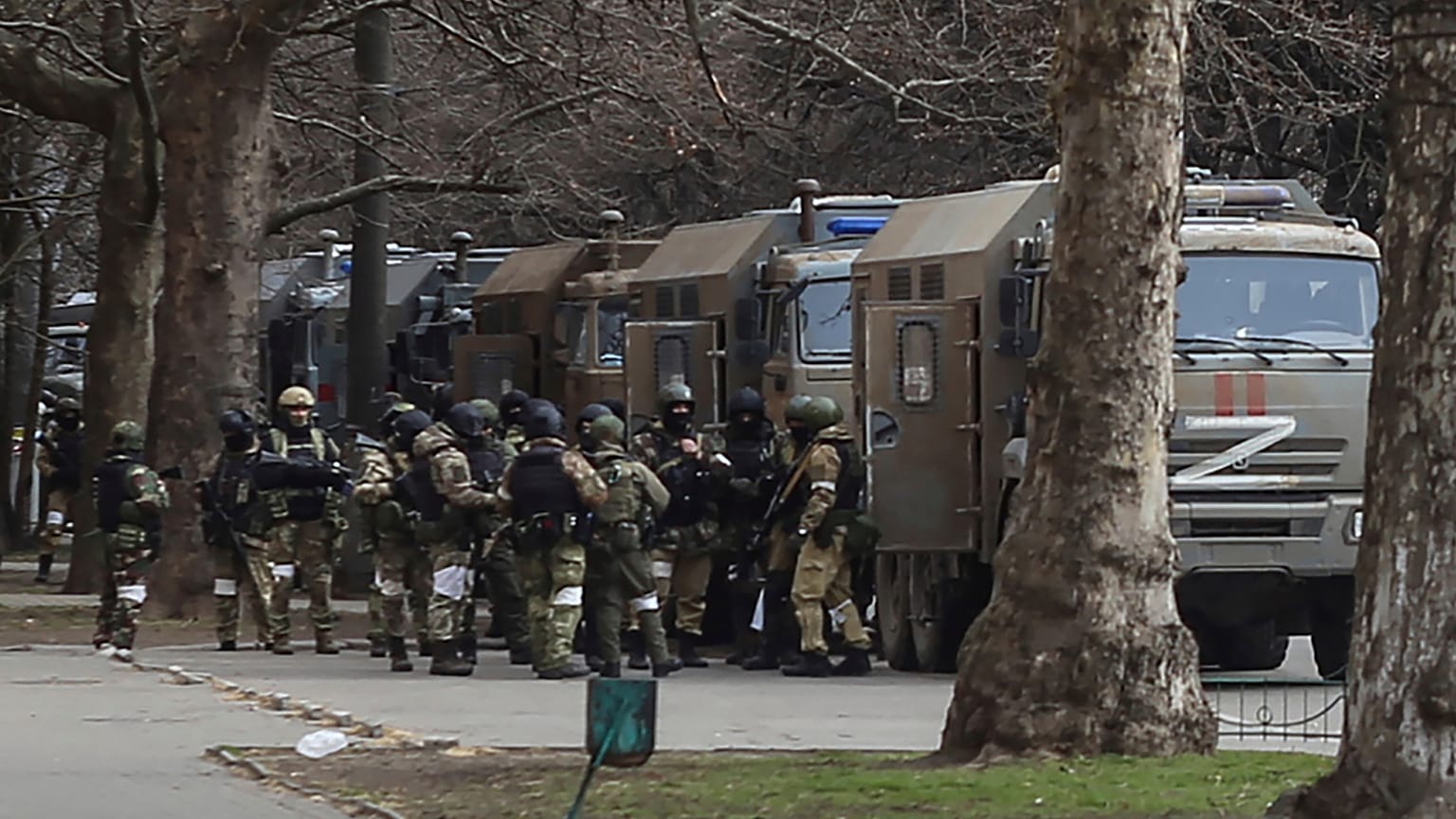 Russian army soldiers stand next to their trucks during a rally against Russian occupation in Svobody (Freedom) Square in Kherson, Ukraine, on March 7, 2022.