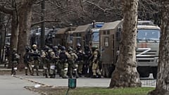 Russian army soldiers stand next to their trucks during a rally against Russian occupation in Svobody (Freedom) Square in Kherson, Ukraine, on March 7, 2022.