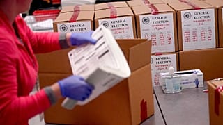 An election worker boxes tabulated ballots inside the Maricopa County Recorders Office, Wednesday, Nov. 9, 2022, in Phoenix.