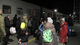 Kherson evacuees board trains at Crimea station in late October